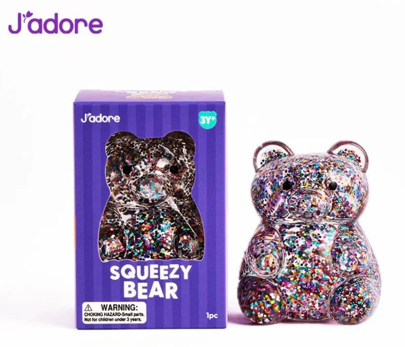 J'adore Squeezy Bear purple box next to the multicolor glitter bear squishy