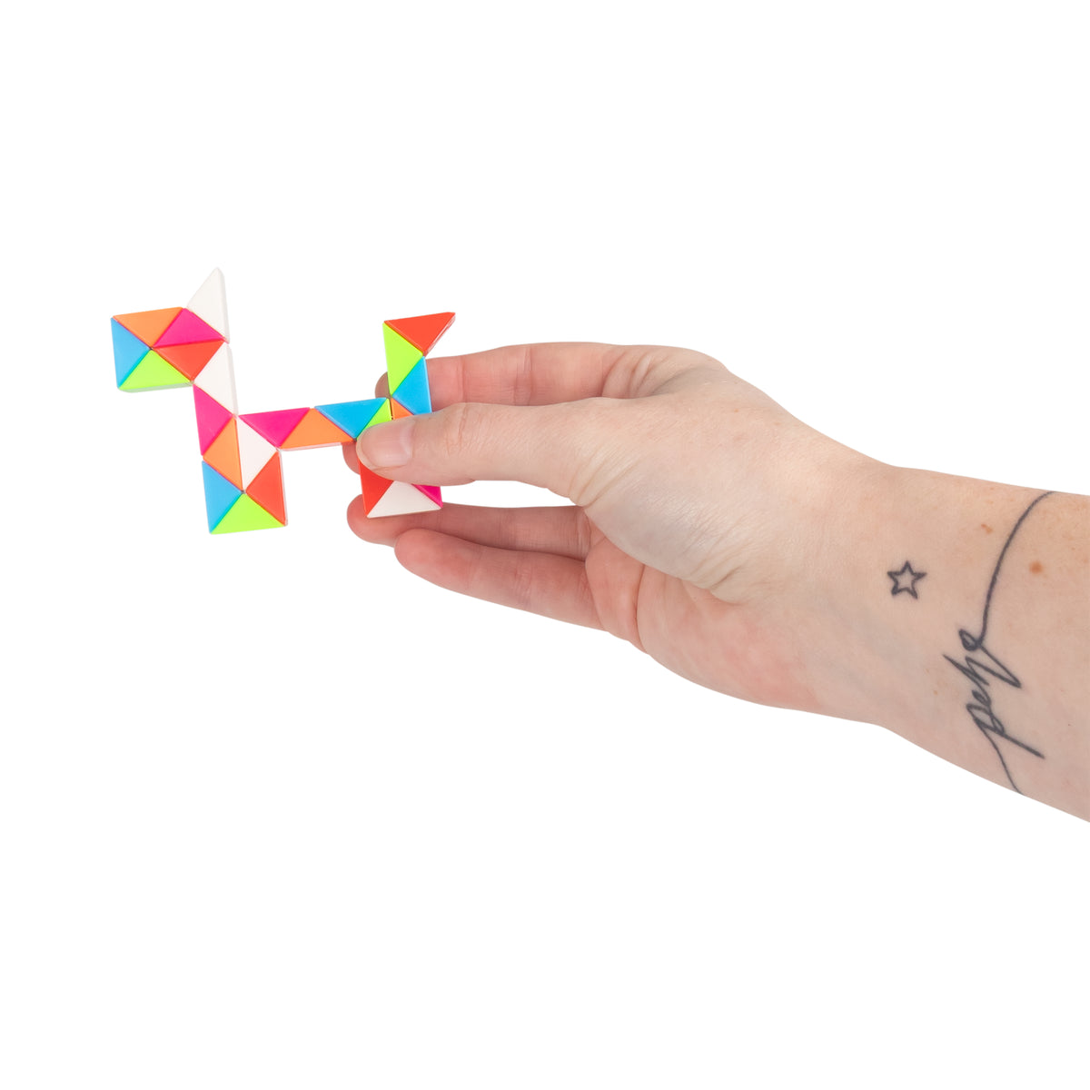 Hand holding a rainbow snake puzzle cube from the Sensory Surprise mystery bag