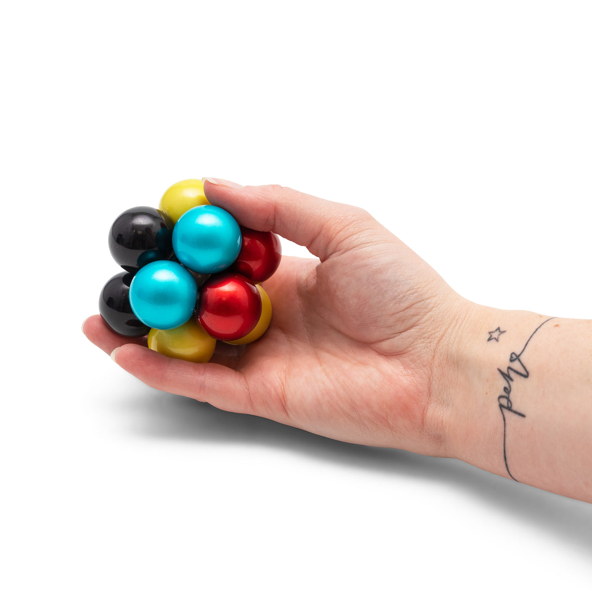 Hand squeezing the Atomic Fidget Ball multicolor interlocking bead toy
