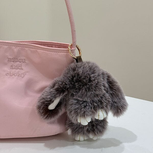 Bao Bunny furry kawaii plush keychain attached to a pink purse