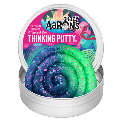 Open tin of Crazy Aaron's Mermaid Tale Glowbrights Thinking Putty showing blue glitter putty glowing green along one side.