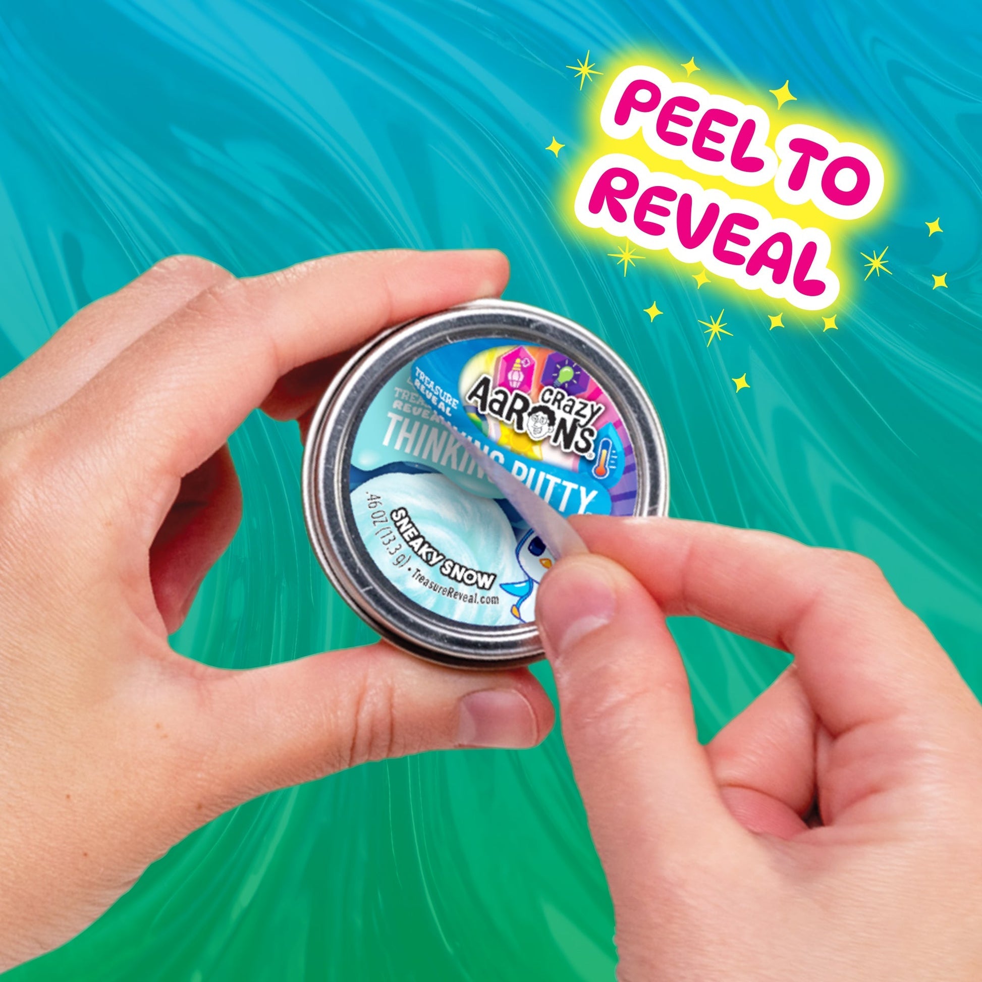 Hands peeling the mystery label from a Crazy Aaron's Treasure Reveal Thinking Putty tin.