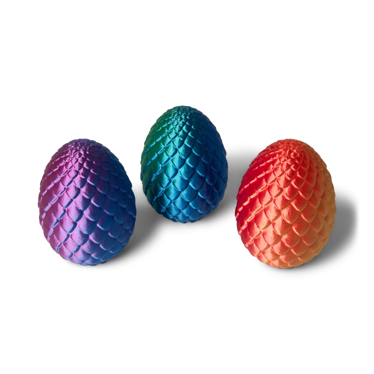All three giant dragon egg colorways displayed together: Purple/Blue, Green/Blue, and Orange/Red