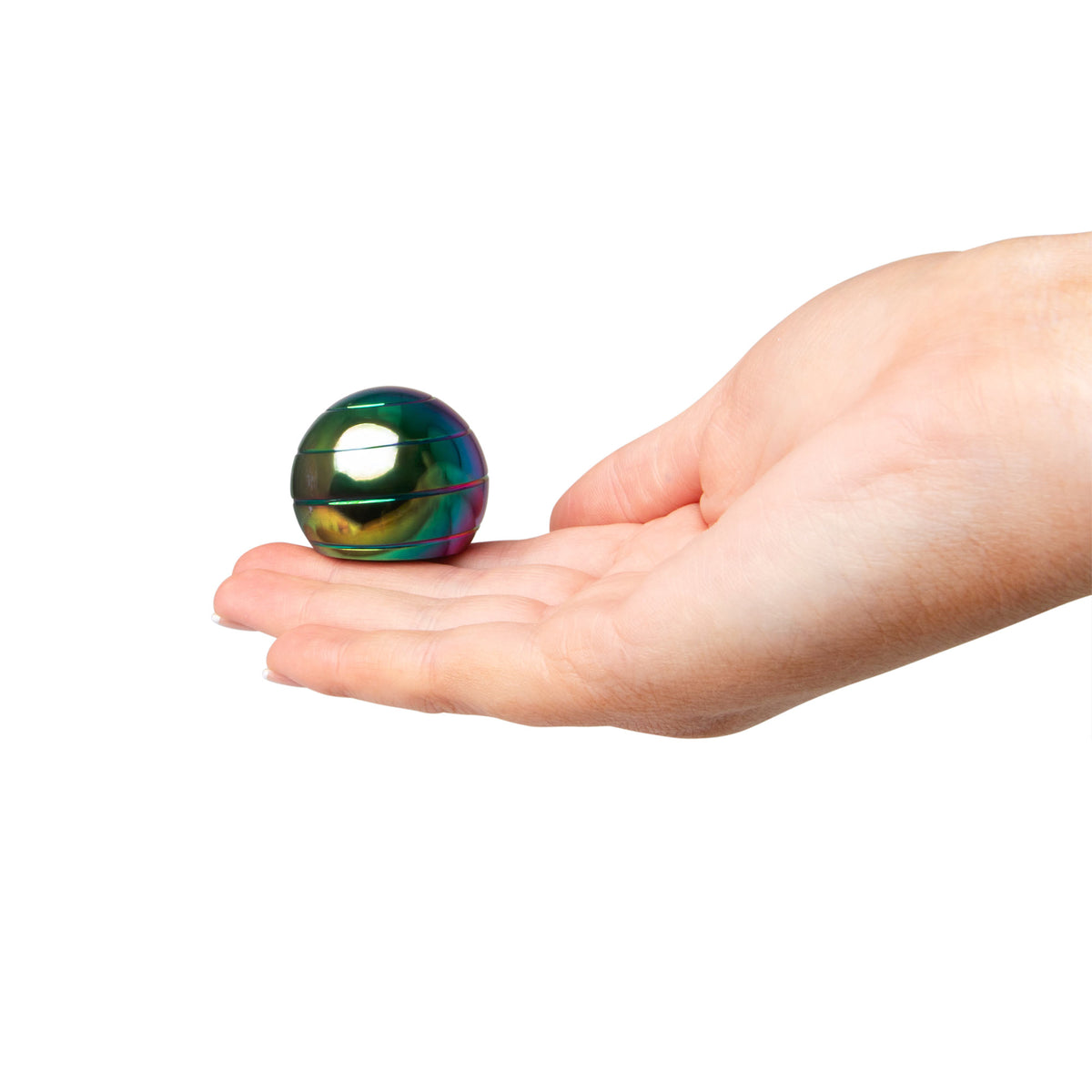 Hand holding the FIDGIX Spinning Sphere in an open palm for scale
