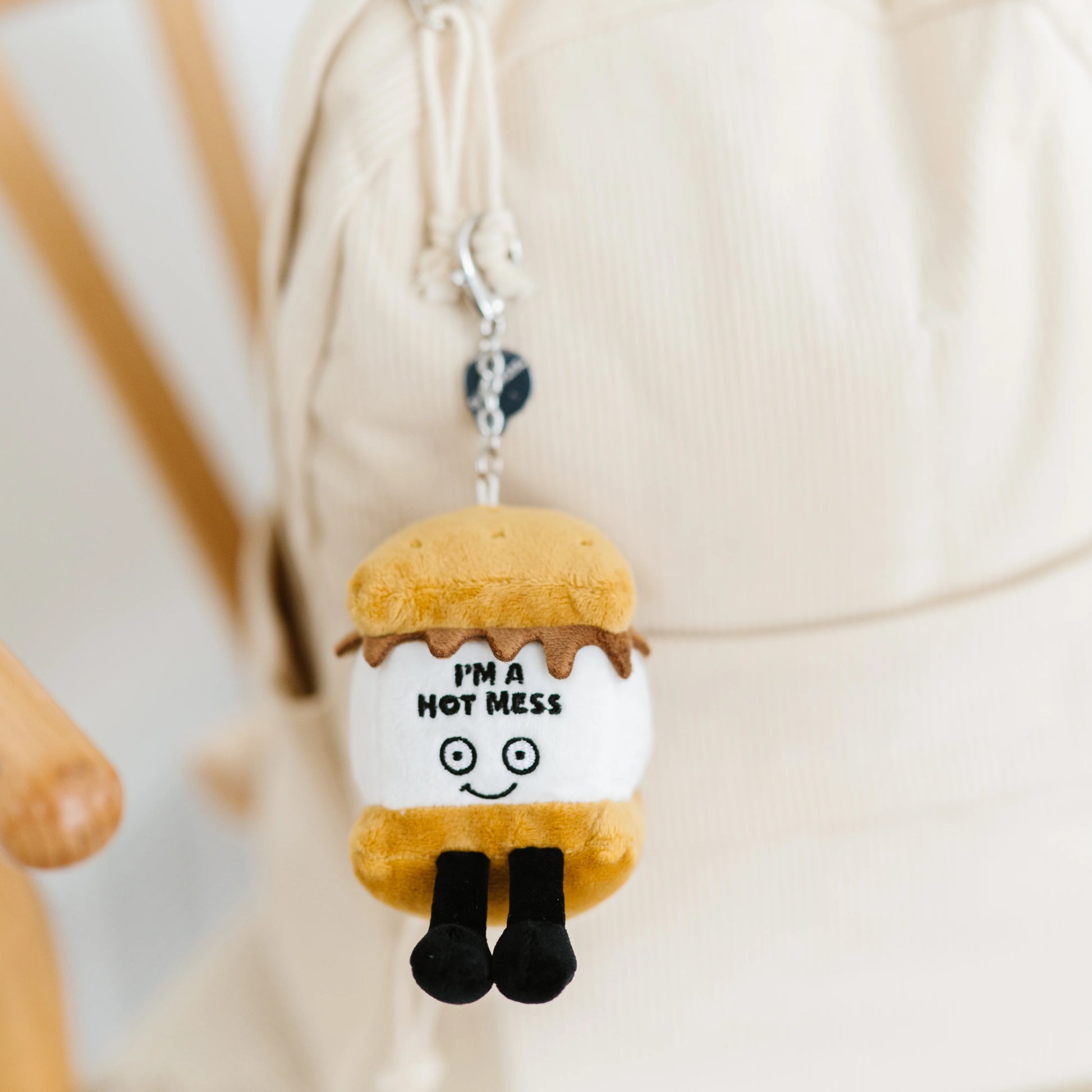 I’m A Hot Mess s’mores plush bag charm hanging on a bag as cute accessory