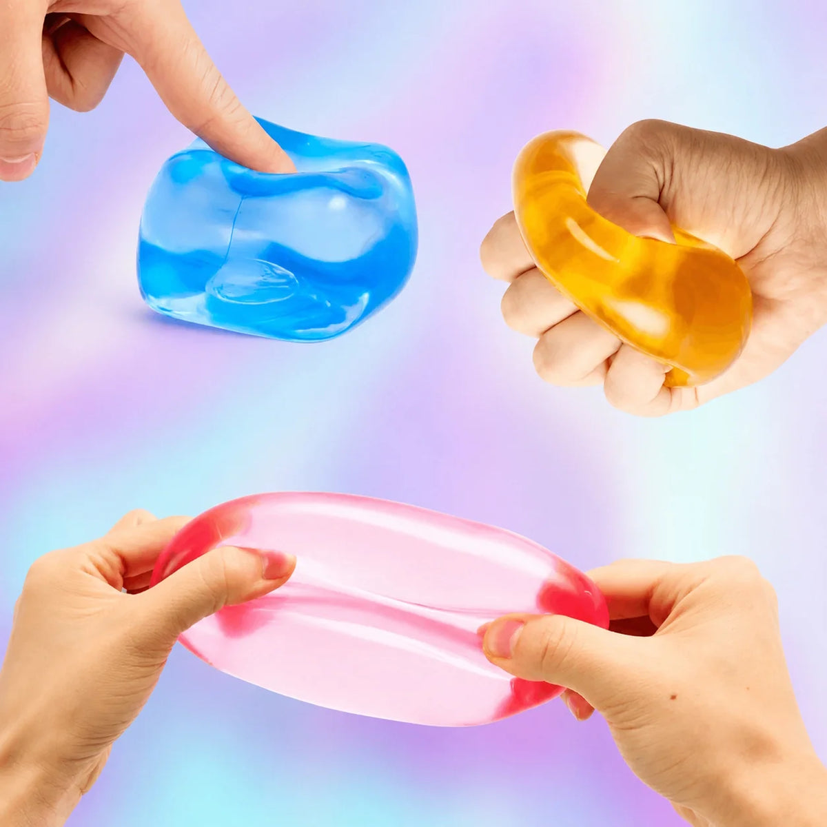 Hands squeezing and stretching soft translucent J'adore Fun Cube squishies