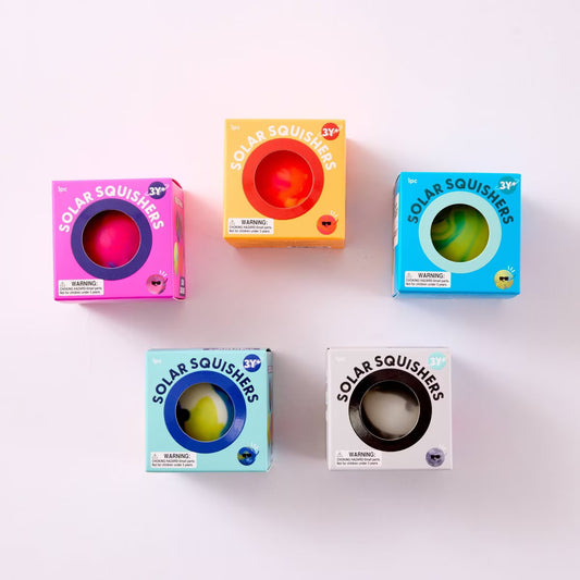 boxed J'adore Solar squishers sensory squeeze toys in assorted colorful packaging.