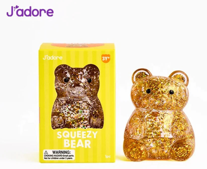 J'adore Squeezy Bear yellow box next to the gold glitter bear squishy