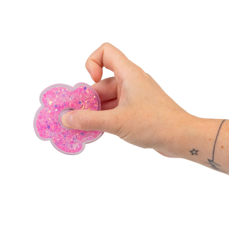 White, purple, and pink Liquid Glitter Fidget Spinners shown together, flat lay