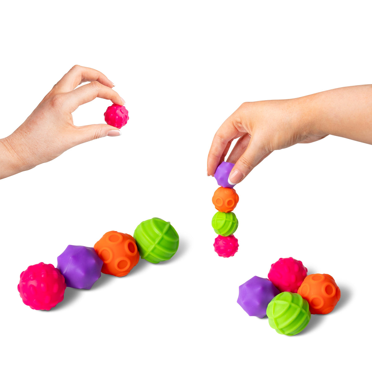 Two hands stacking and arranging colorful textured magnetic sensory spheres into towers and clusters