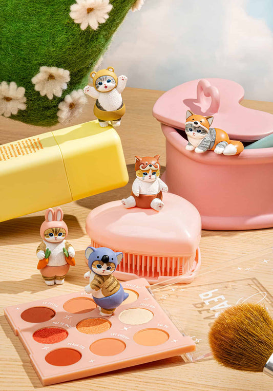 mofusand Meow Pants blind box cat figures displayed on a cute pastel desk