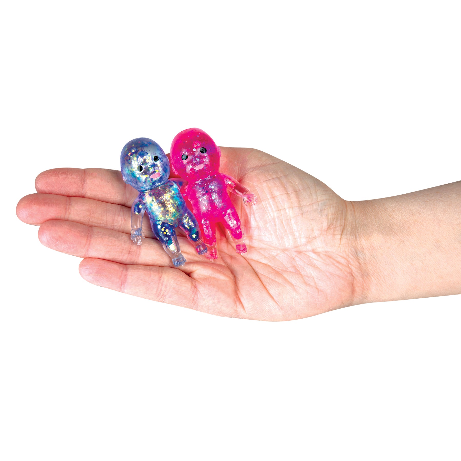 Two ORB Sugar Swaps Babies Twinsies glitter figures displayed in the palm of a hand.