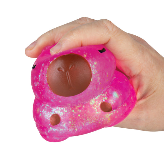 Pink glitter Sparklee Capybara squishy toy compressed during squeeze.
