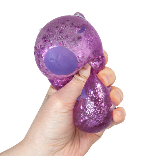 Purple glitter Sparklee Capybara squishy toy being squeezed by hand.