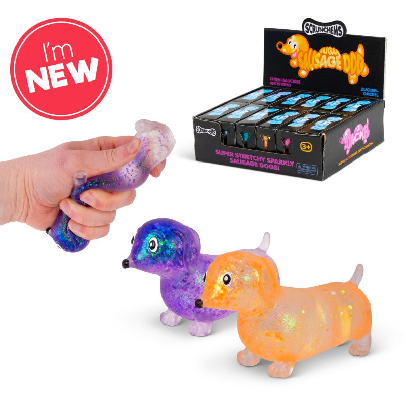 Hand squeezing a purple and white glitter Sparkly Sausage Dog squishy toy