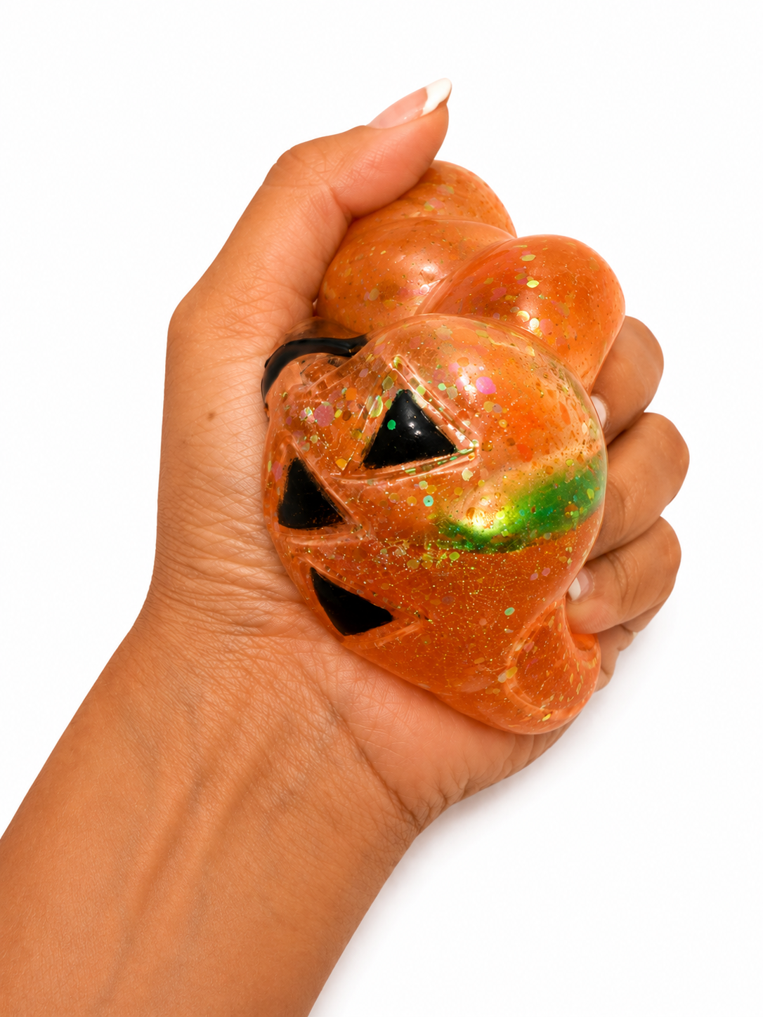 Hand squeezing Zorbitz Squish N' Sparkle Pumpkin