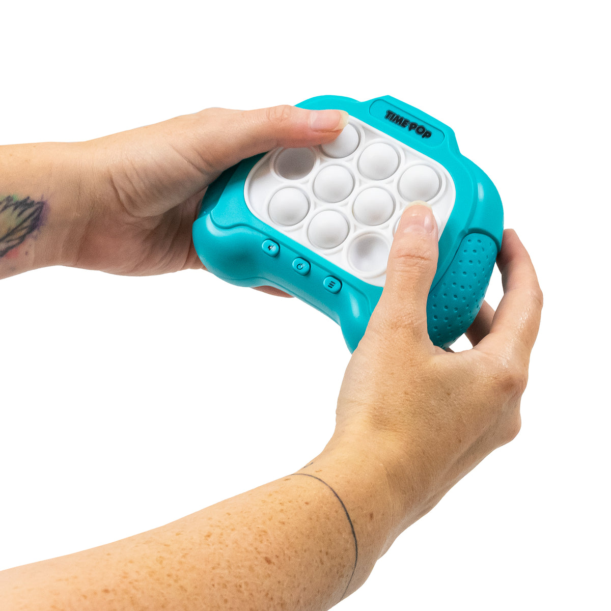 Hands opening the battery compartment on the back of the pink Time Pop game