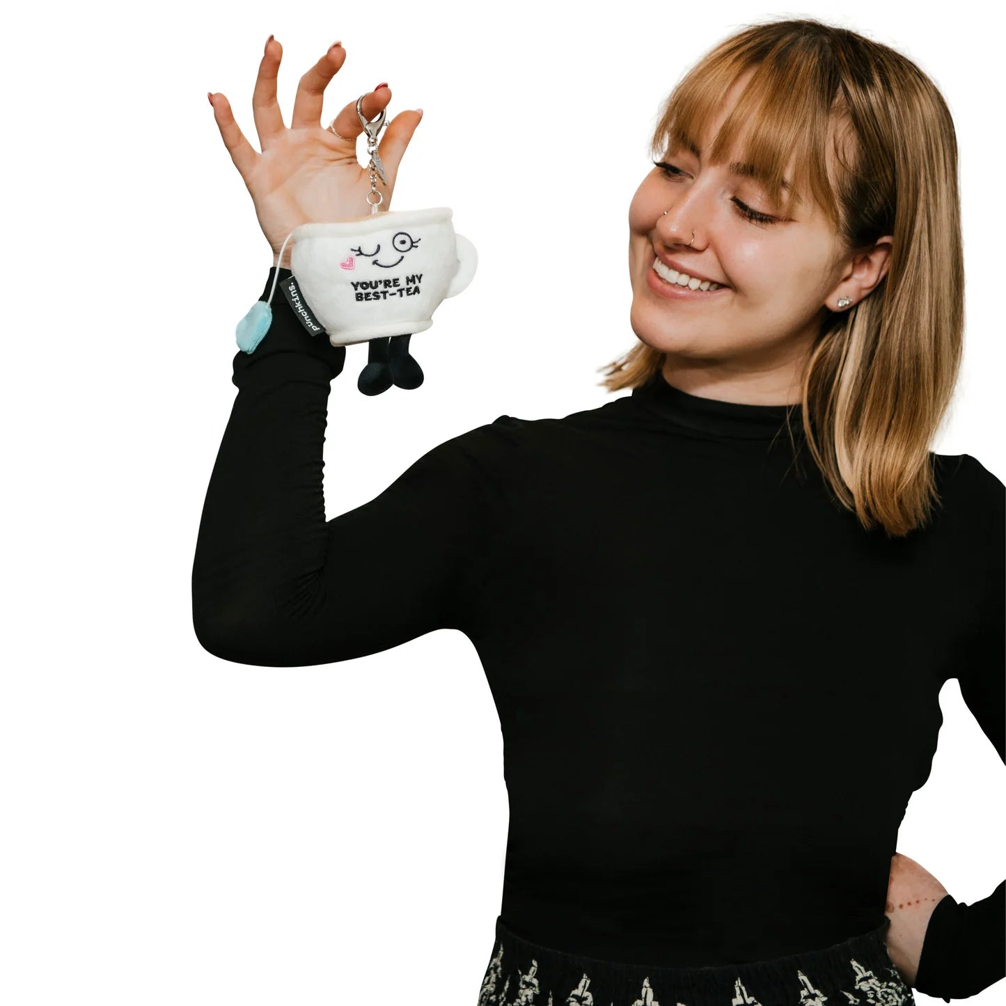 Woman holding You’re My Best-Tea plush teacup keychain charm showing size